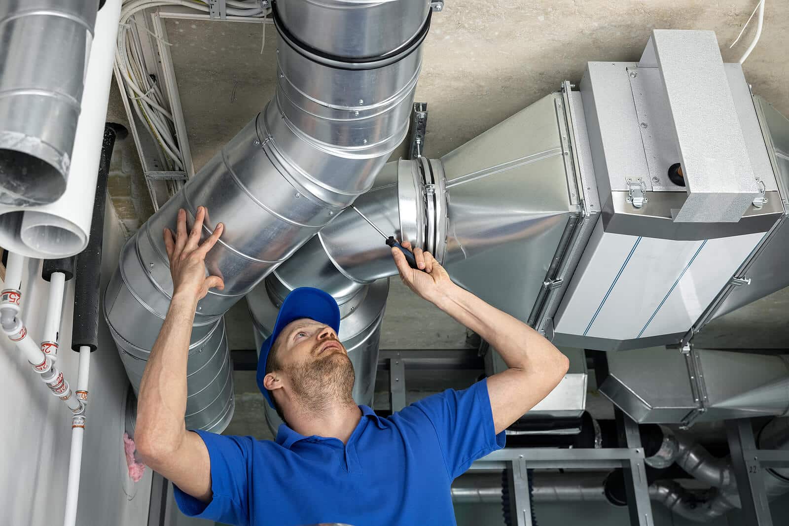 HVAC technician inspecting and repairing air ducts in Fremont