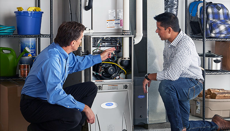 Technician evaluating a furnace for repair or replacement in Fremont