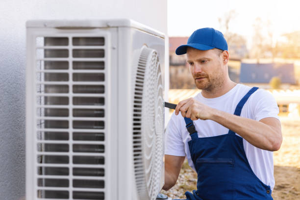 HVAC technician servicing an outdoor air conditioner in Fremont
