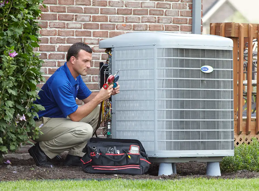 HVAC technician inspecting an outdoor AC unit in Fremont