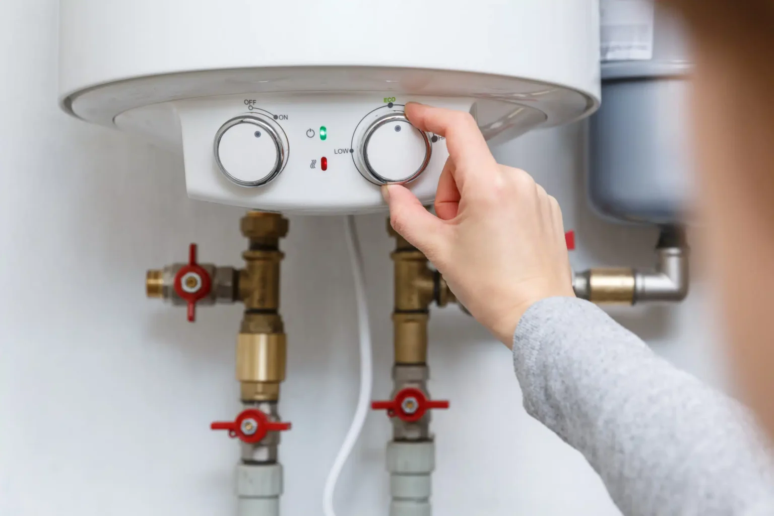 Technician adjusting a water heater in Fremont
